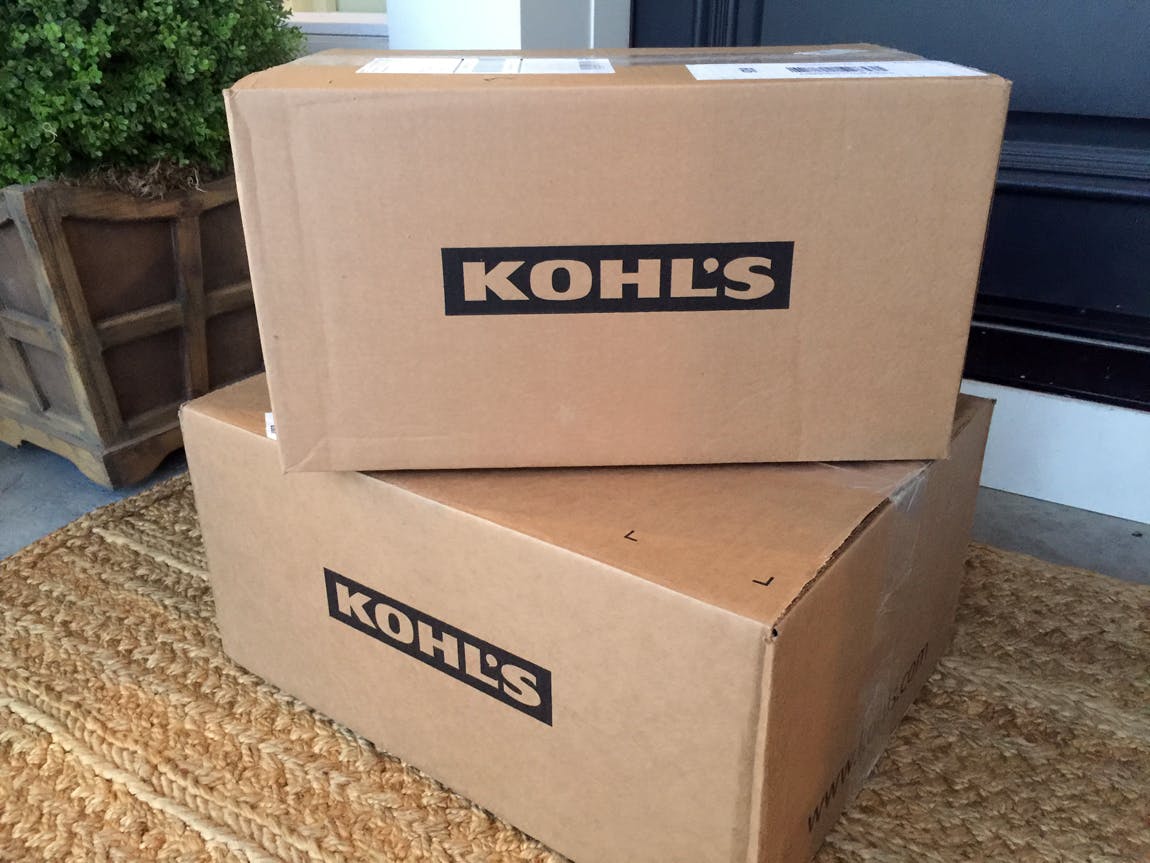 Two Kohl's delivery boxes stacked on a front porch.