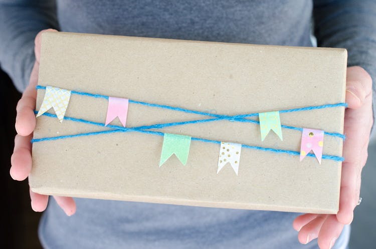 Decorate presents with twine and washi-tape flags.