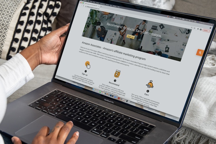 A person on a computer, looking at the Amazon Associates page.