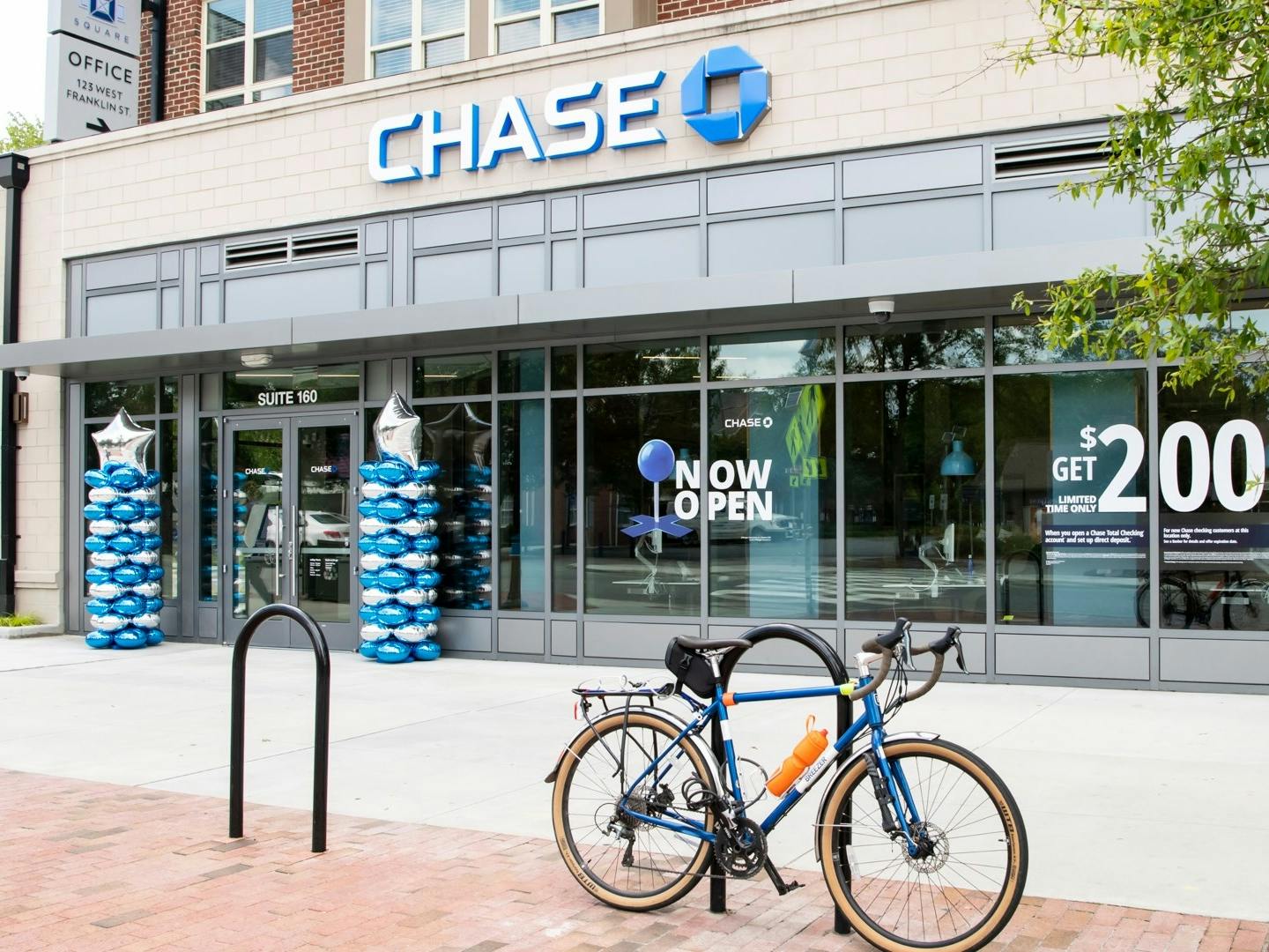 The exterior of a Chase bank location with a bike parked out front.