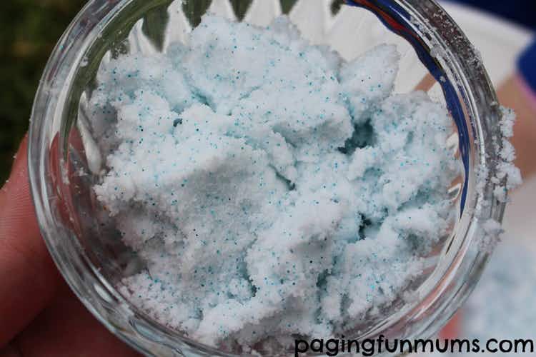 A jar with shaving cream, baking soda and blue glitter to look like foaming snow. 