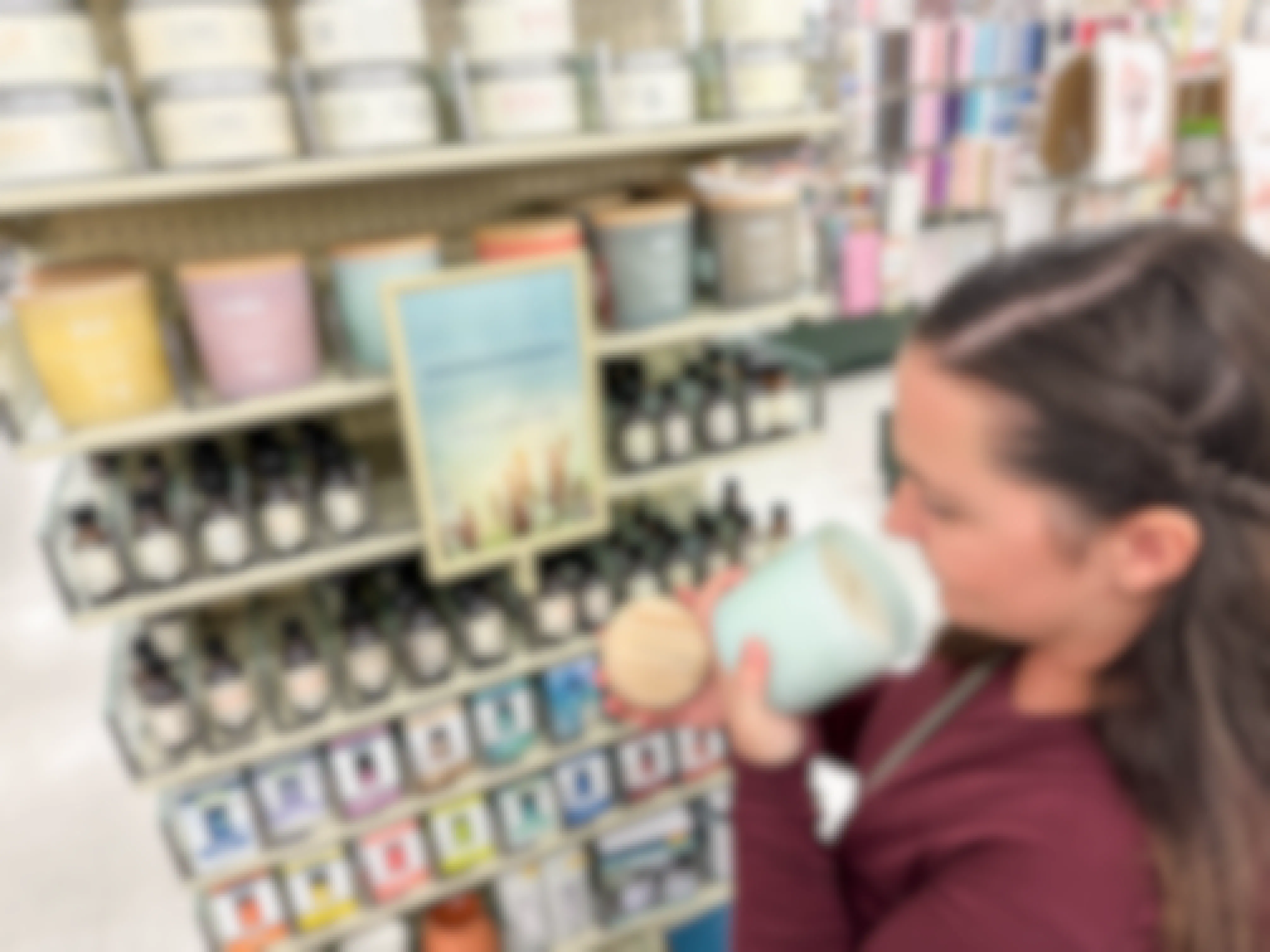 a woman smelling a candle in hobby lobby 