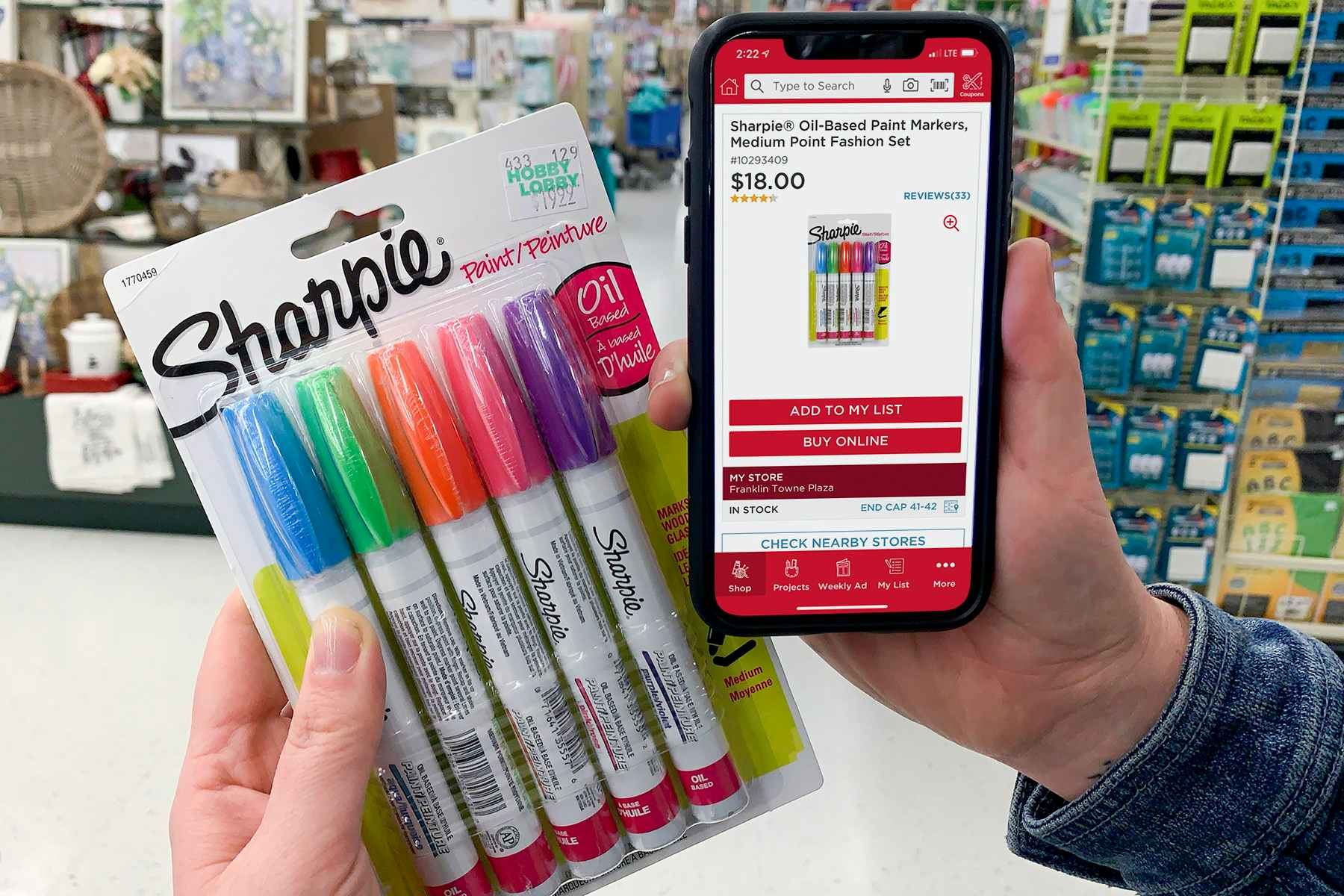 A cell phone showing the price of Sharpie Paint pens at Michaels with a pack of the same paint pens, featuring a higher price at Hobby Lobby.