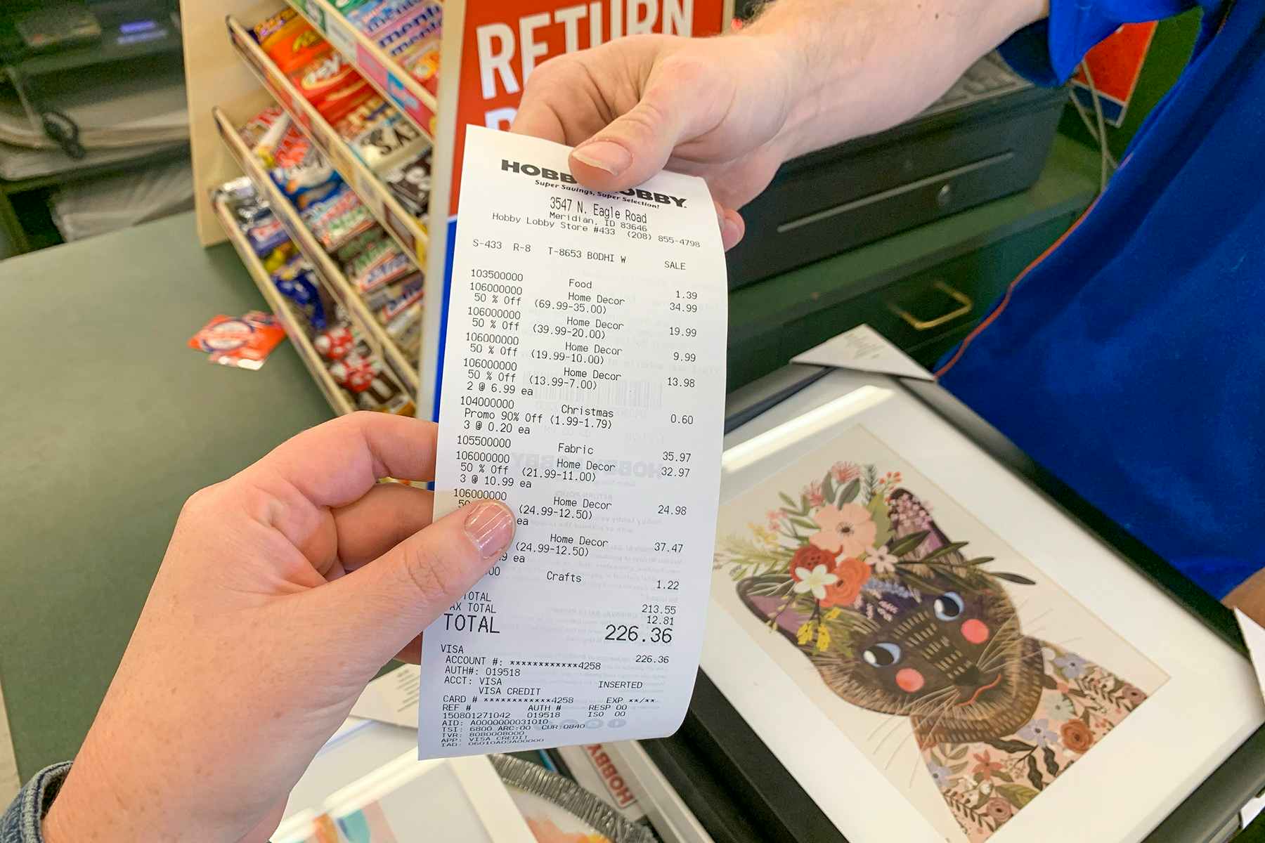 An employee handing a receipt back to a customer.