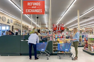 People in line at the Refunds and Exchanges checkout register.