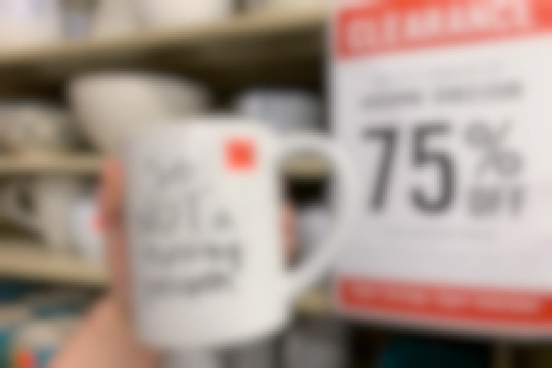 A mugA mug that says "so not a morning person" with a red clearance sticker stuck to it, held up next to a clearance sign that ready "home decor 75% off".