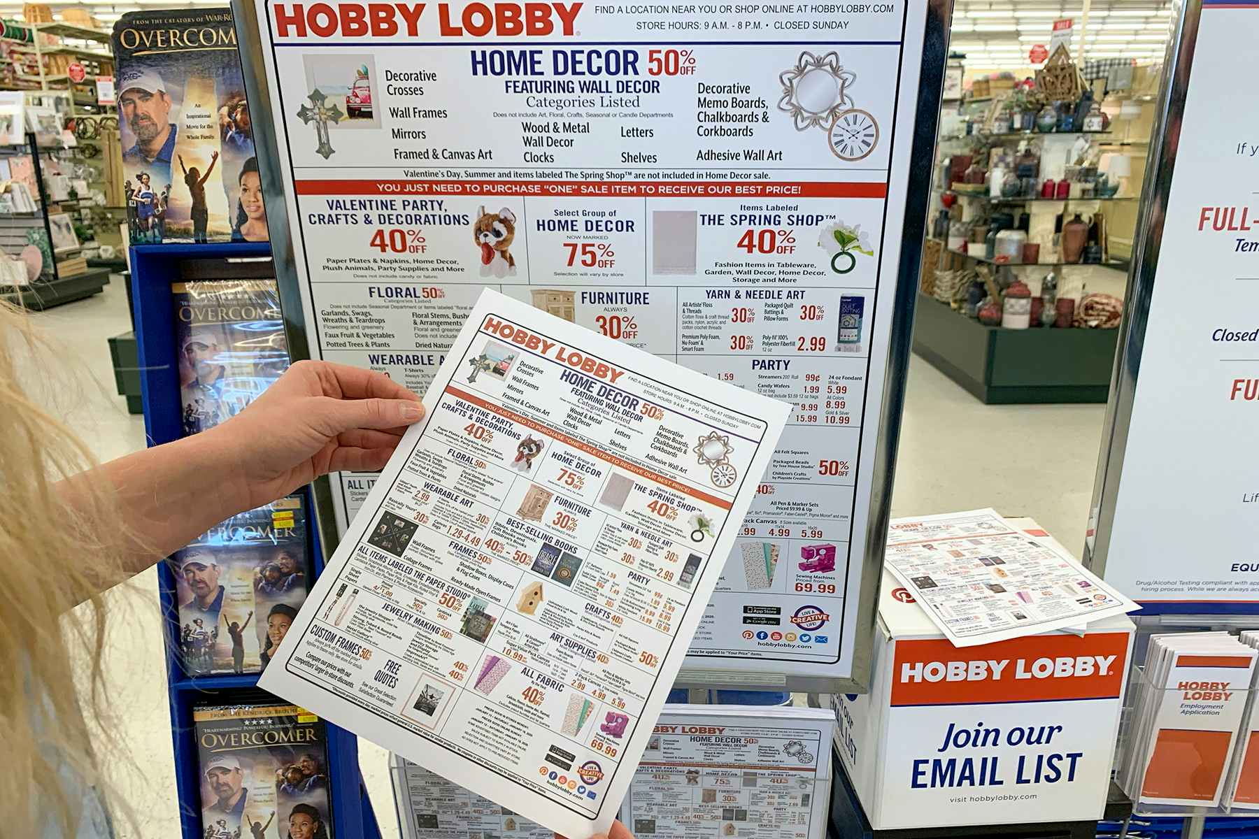 A woman looking at the sales schedule flyer.
