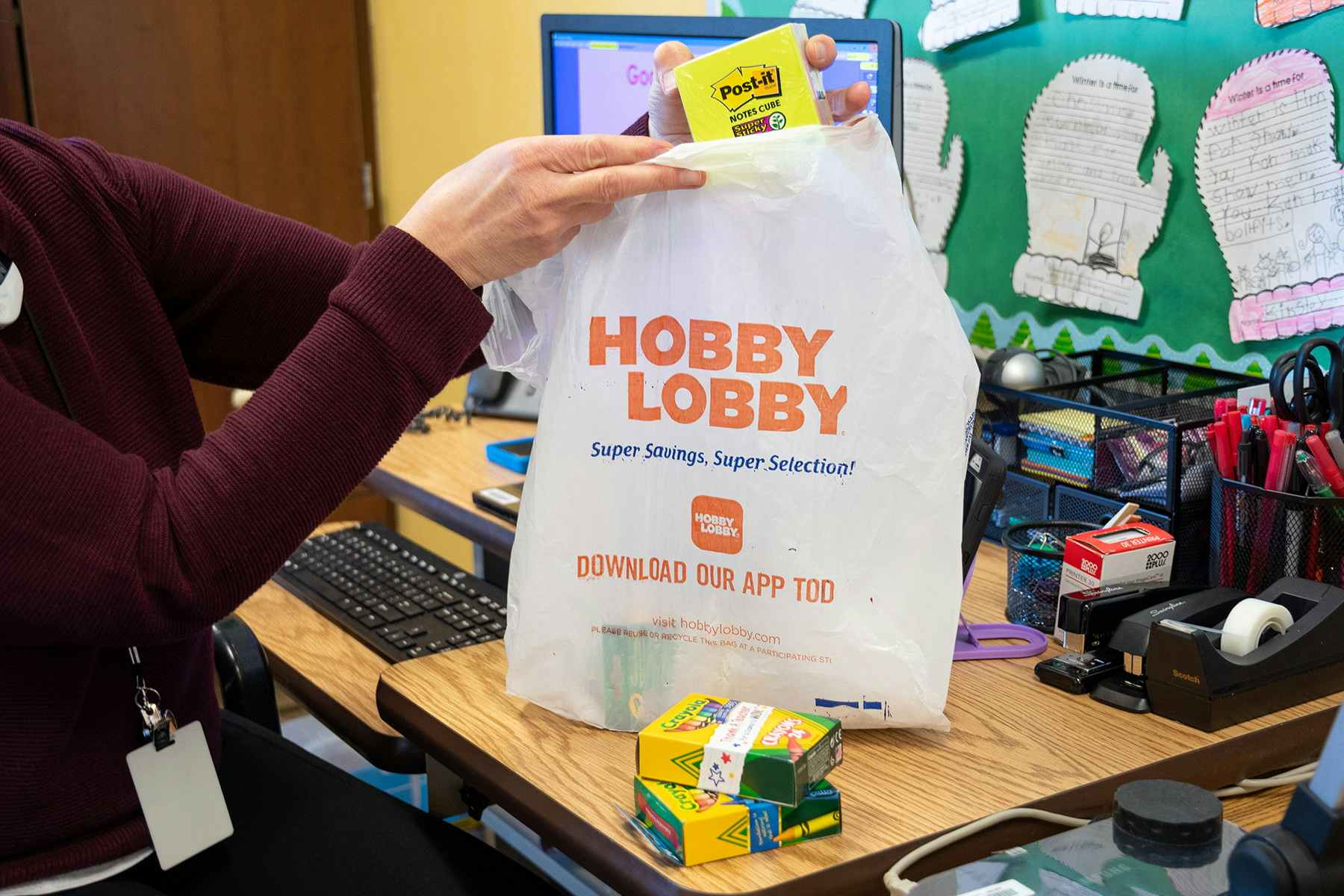 Postit Notes being pulled from a Hobby Lobby shopping bag in a grade school class room.