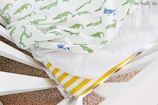 Make middle-of-the-night diaper blowouts easier by adding a double layer of bedding.