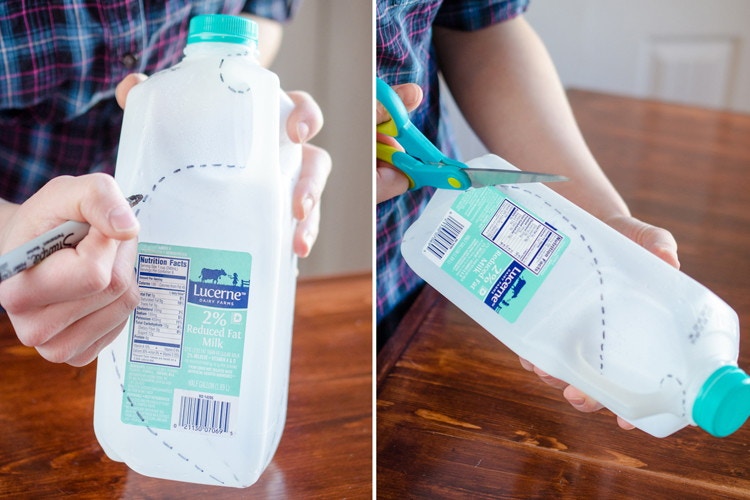 A person cutting a milk jug.