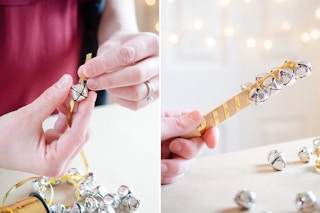 someone putting bells on a ribbon and wrapping it around a popsicle stick