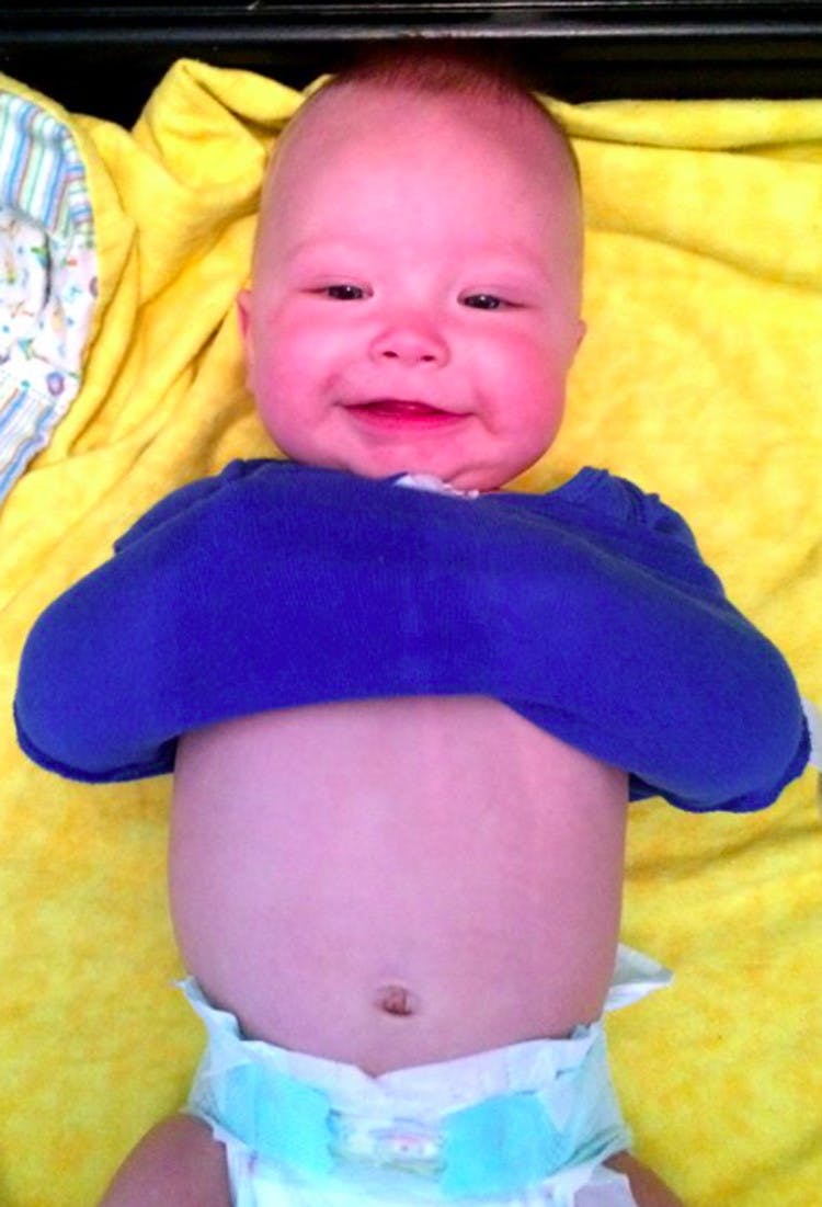 Keep baby from interfering during a diaper change by rolling their onesie over their arms.
