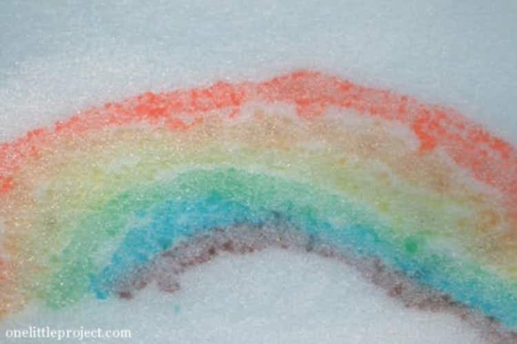 A rainbow painted with colored water in the snow.
