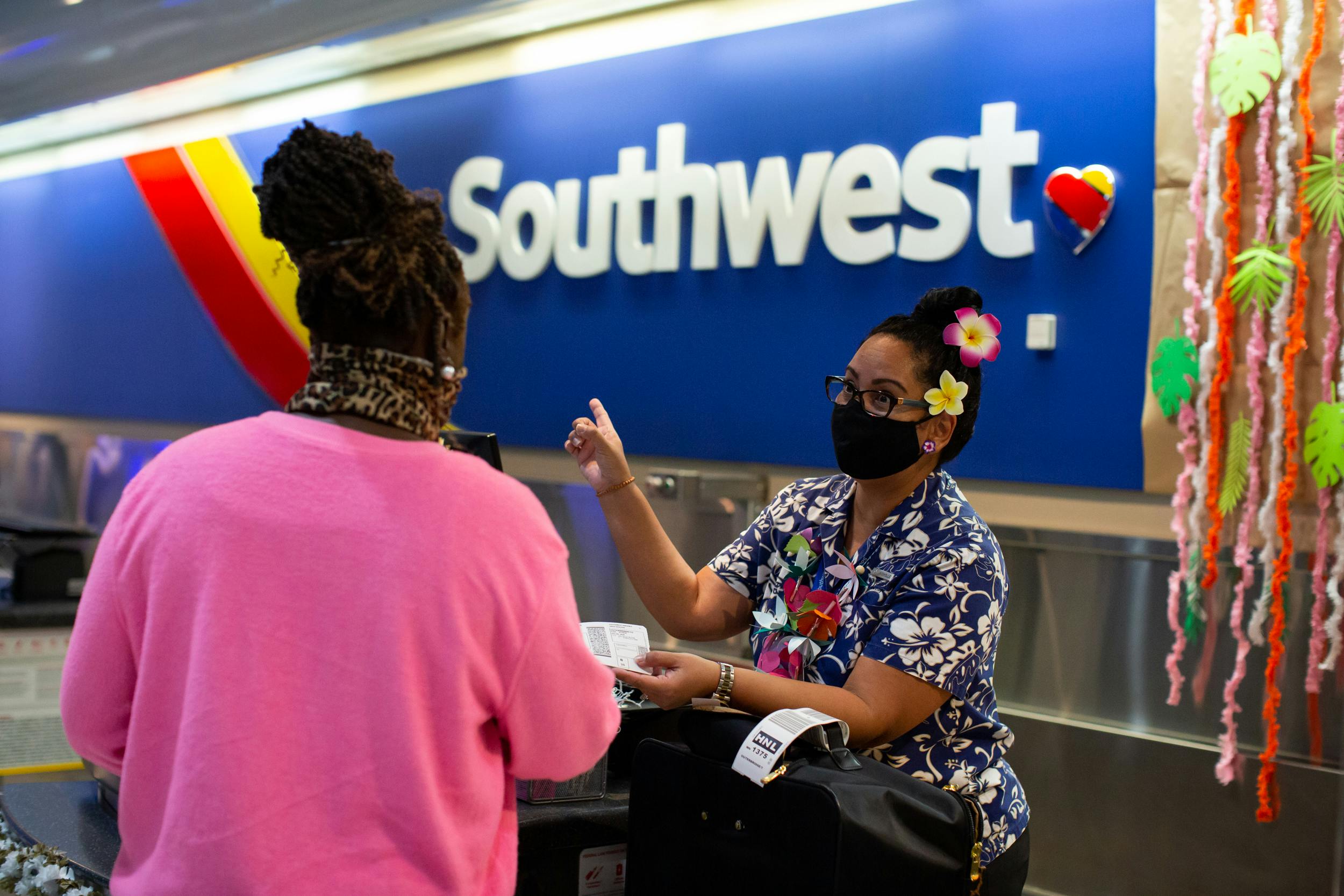 Southwest airlines check in counter with employee and passenger.