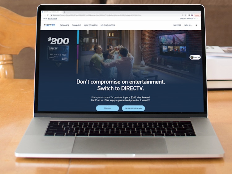 a macbook with the direct tv website pulled up on it