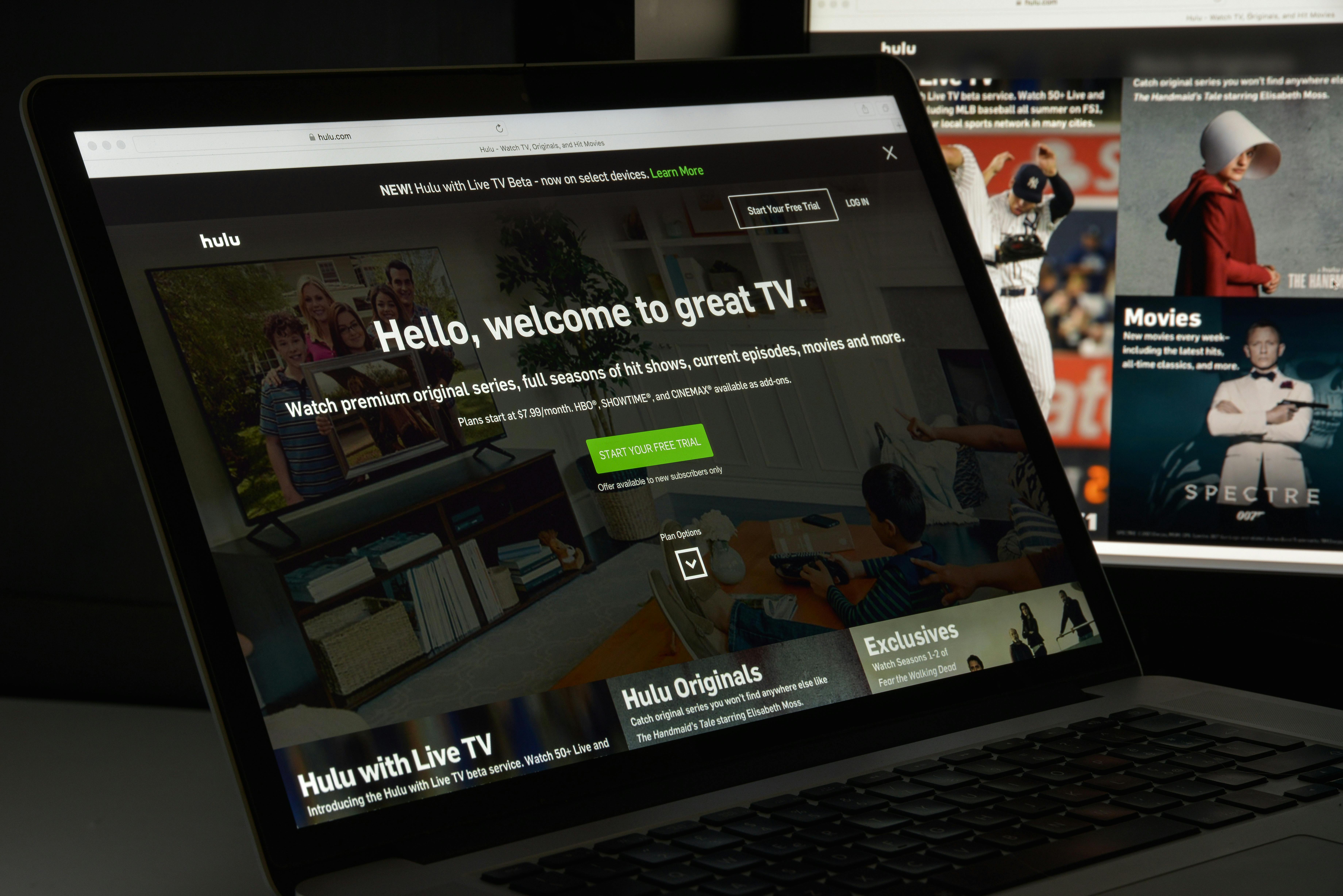 A computer and tv screen displaying Hulu's sign up portal