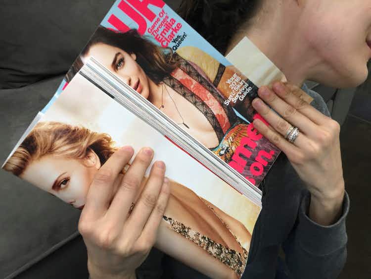 A person holding a magazine.