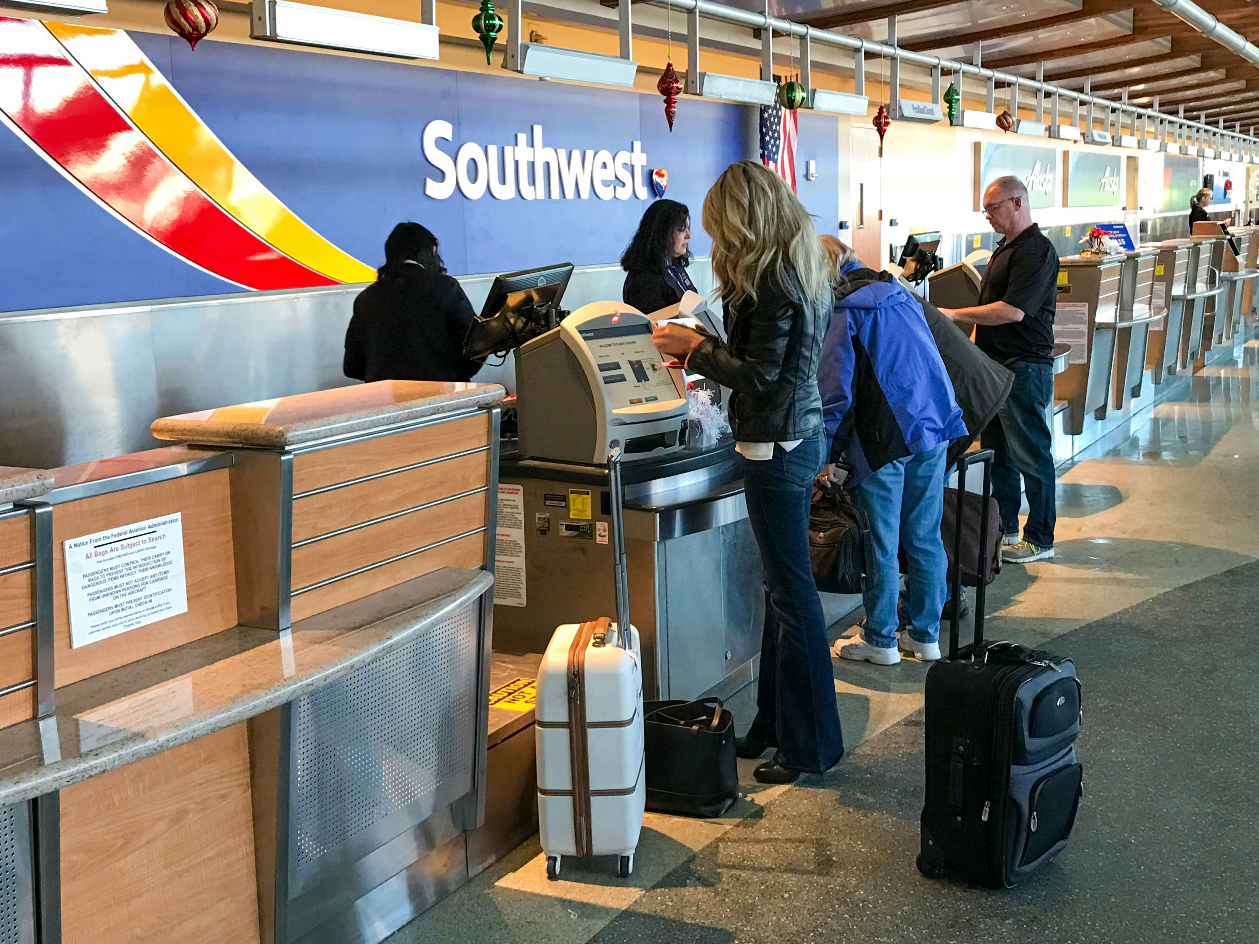 A woman standing at a Southwest counter in an airport.