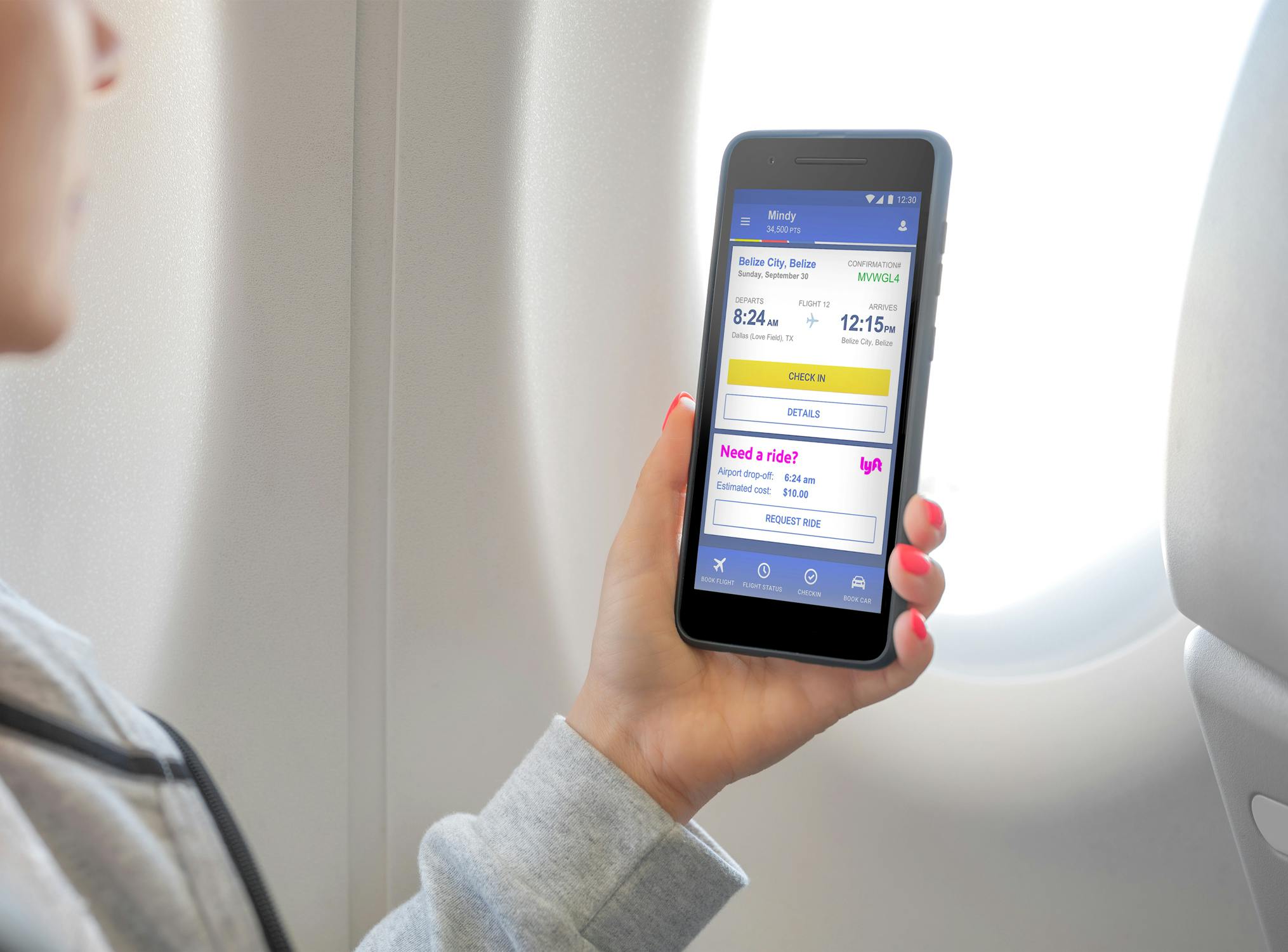 woman holding phone in flight with Southwest app near window