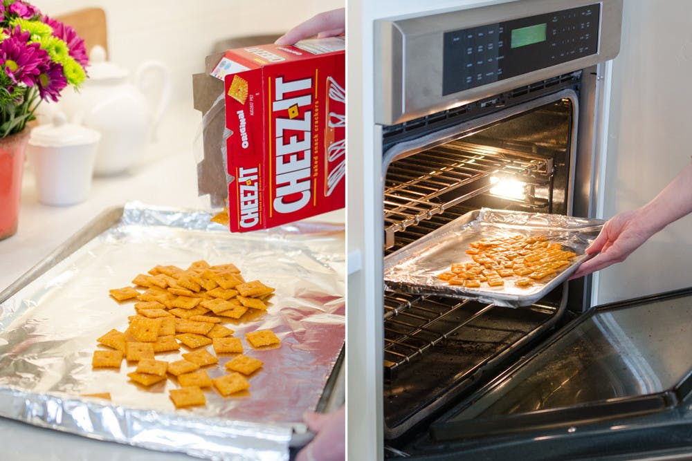 A person pouring Cheez-its onto cookie sheet next to a person placing a pan of Cheez-its into an oven.