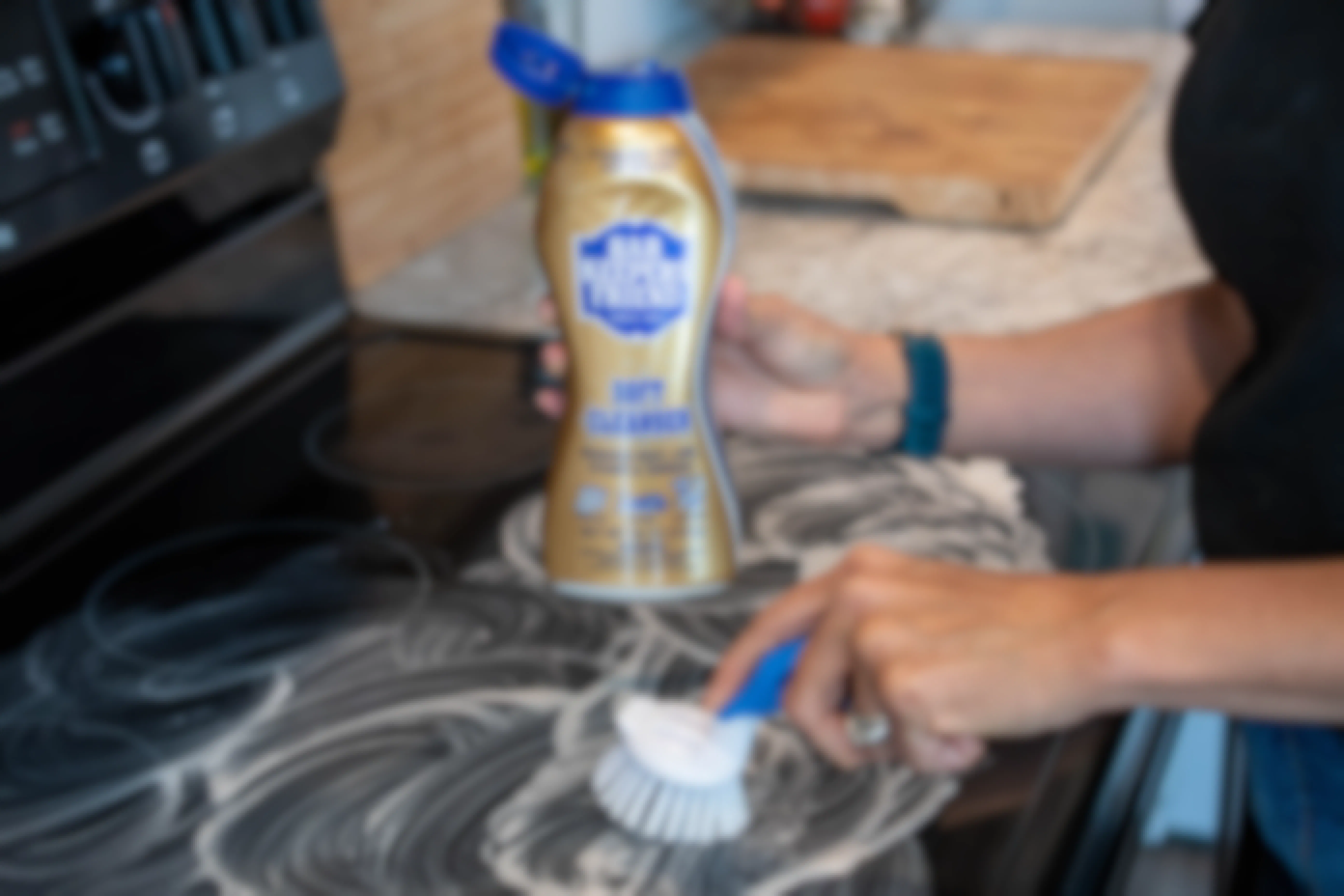 Bar Keepers Friend being used to clean a cooktop stove