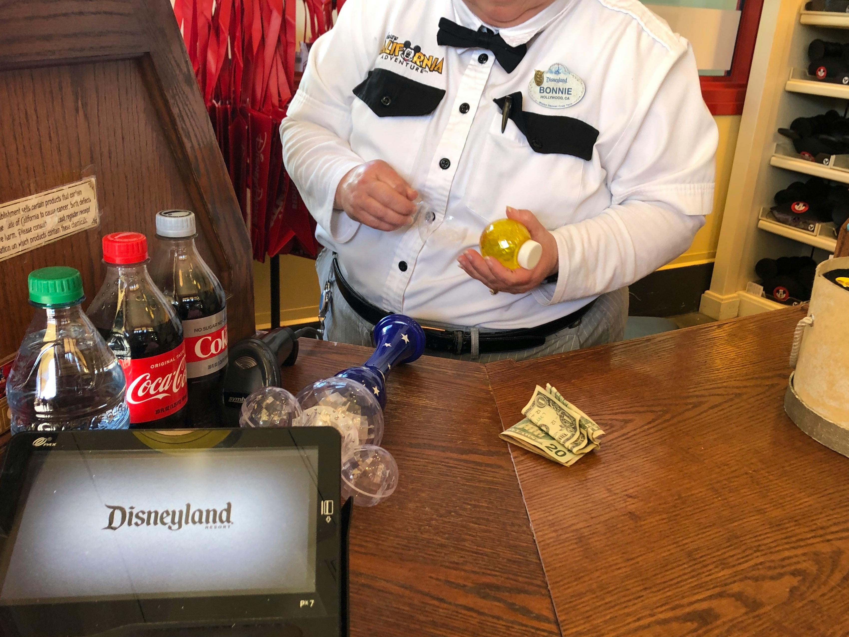 An souvenir is purchased at Disneyland.