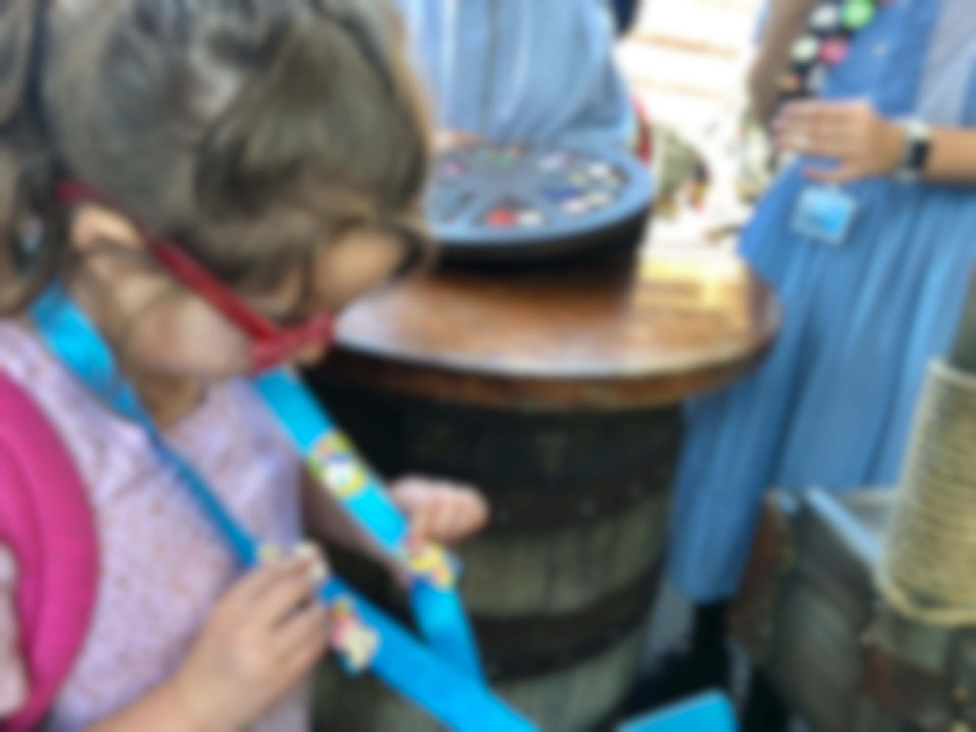 A little girl trades pins at Disneyland.