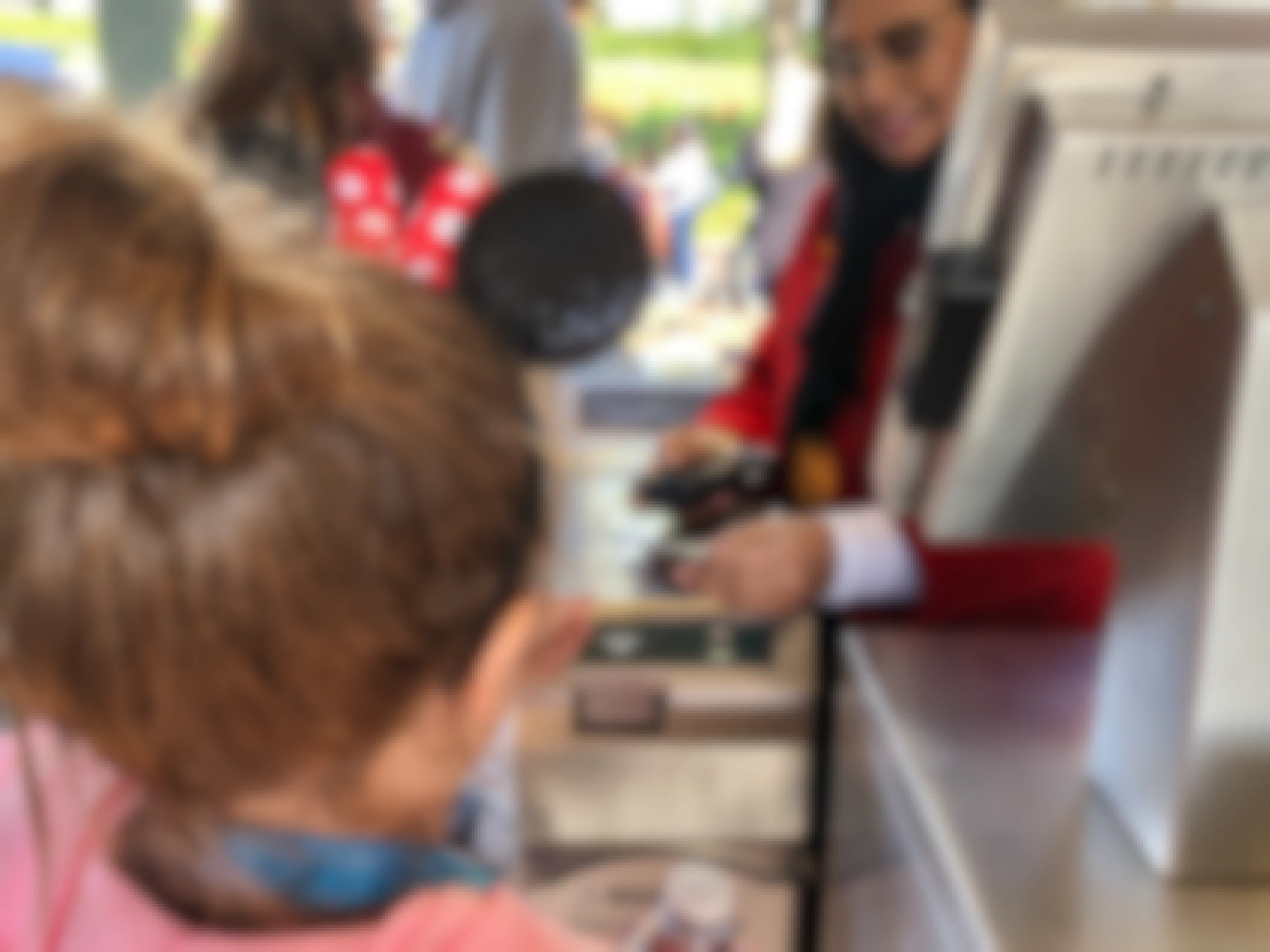 A little girl scans her ticket at the entrance of Disneyland