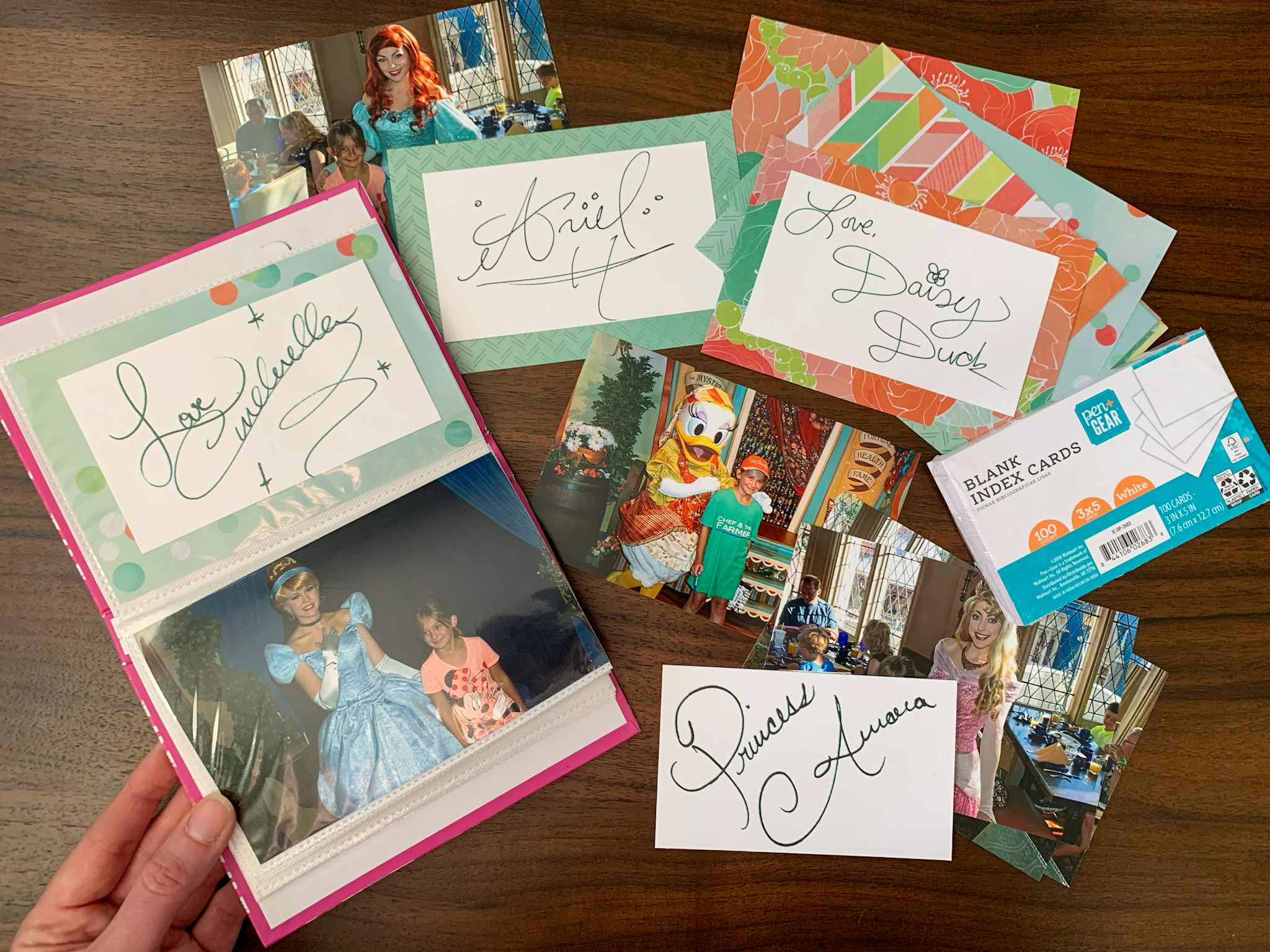 Disney Character photos and autographs assembled into a small dollar store photo album.