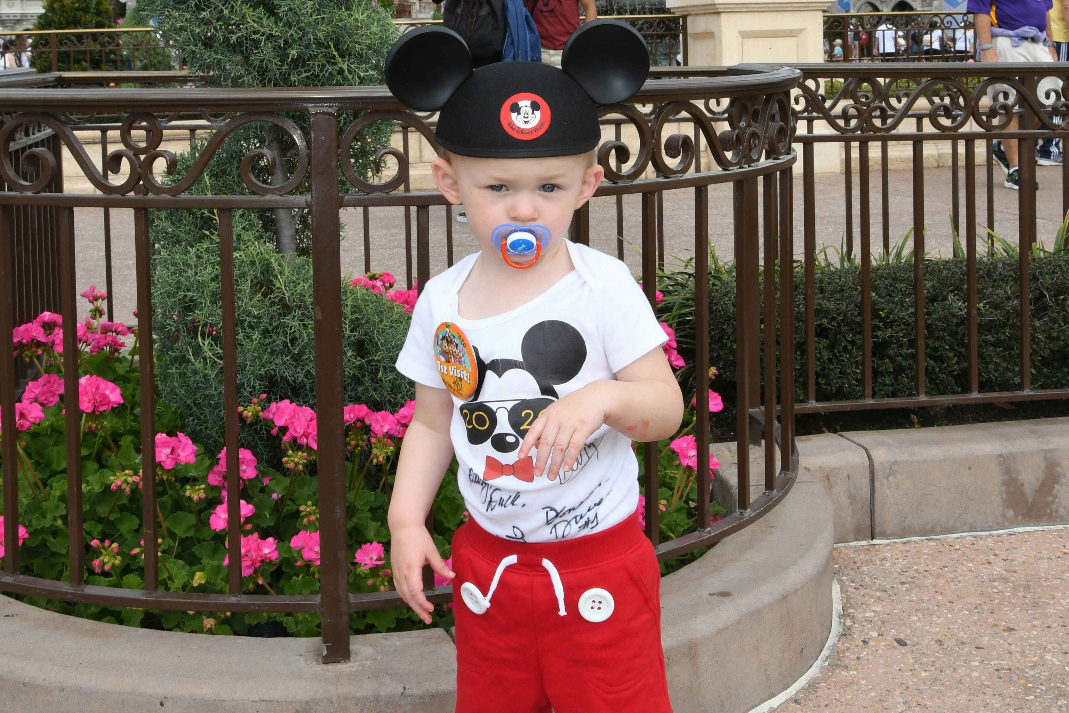 kid wearing mickey mouse ears