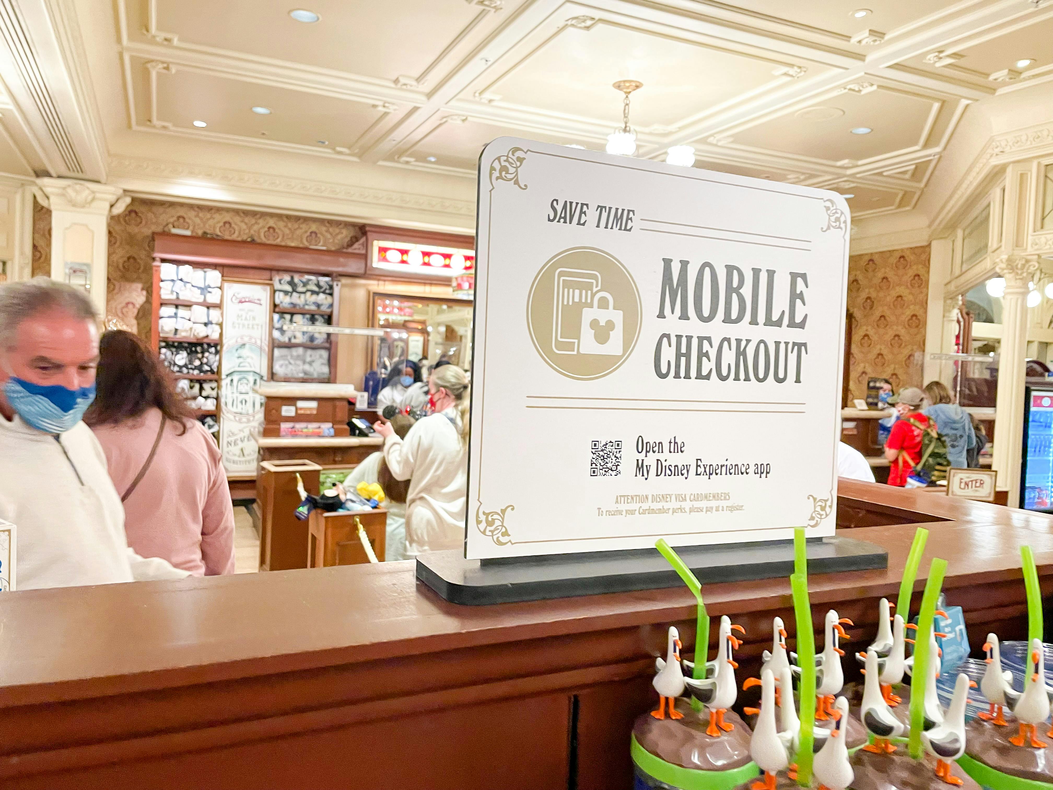A sign advertising Mobile Checkout inside a gift shop at Disney.