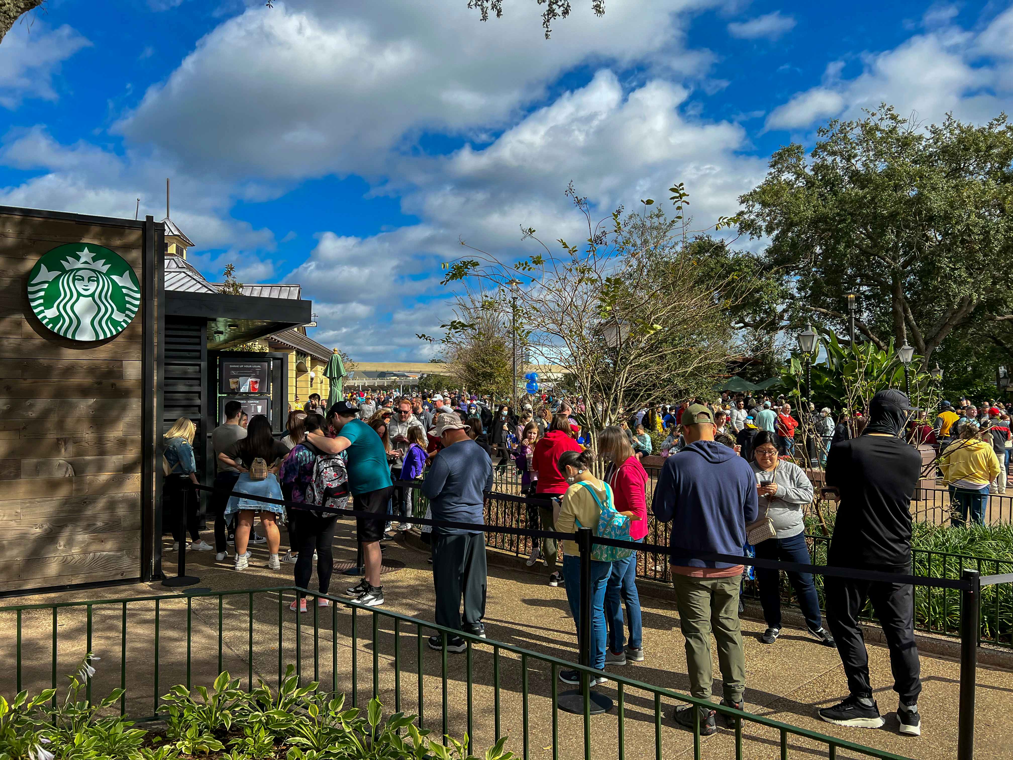 People waiting in a long line for the Starbucks inside the Disney World park.
