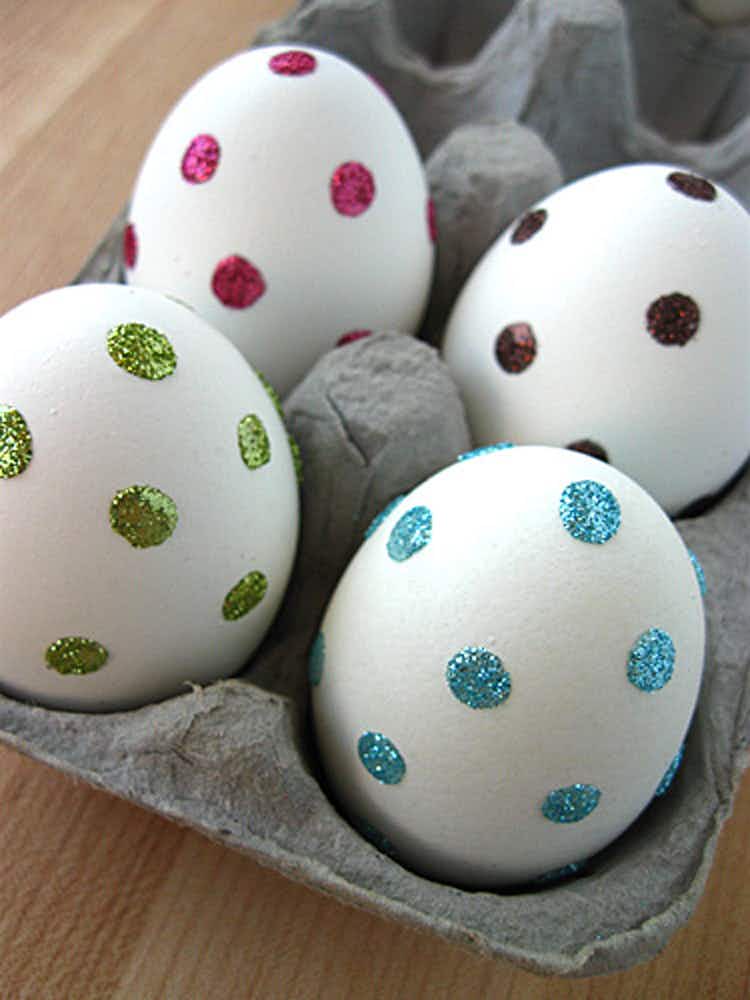Stick clear adhesive dots onto eggs and dip in sprinkles or glitter for easy decorating.