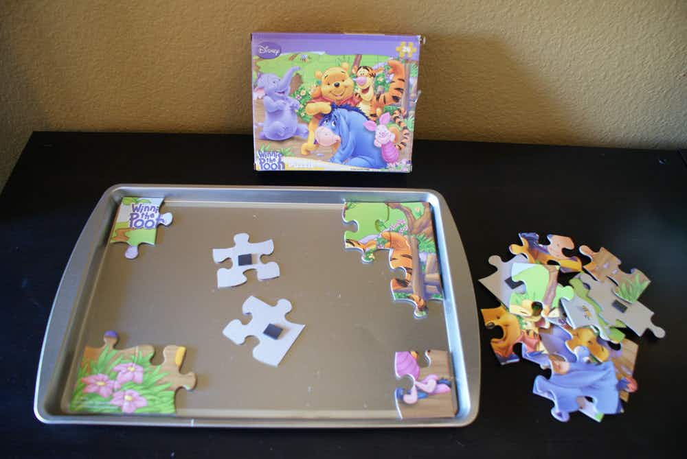 Stick magnets to puzzle pieces and transform a baking sheet into a puzzle board.