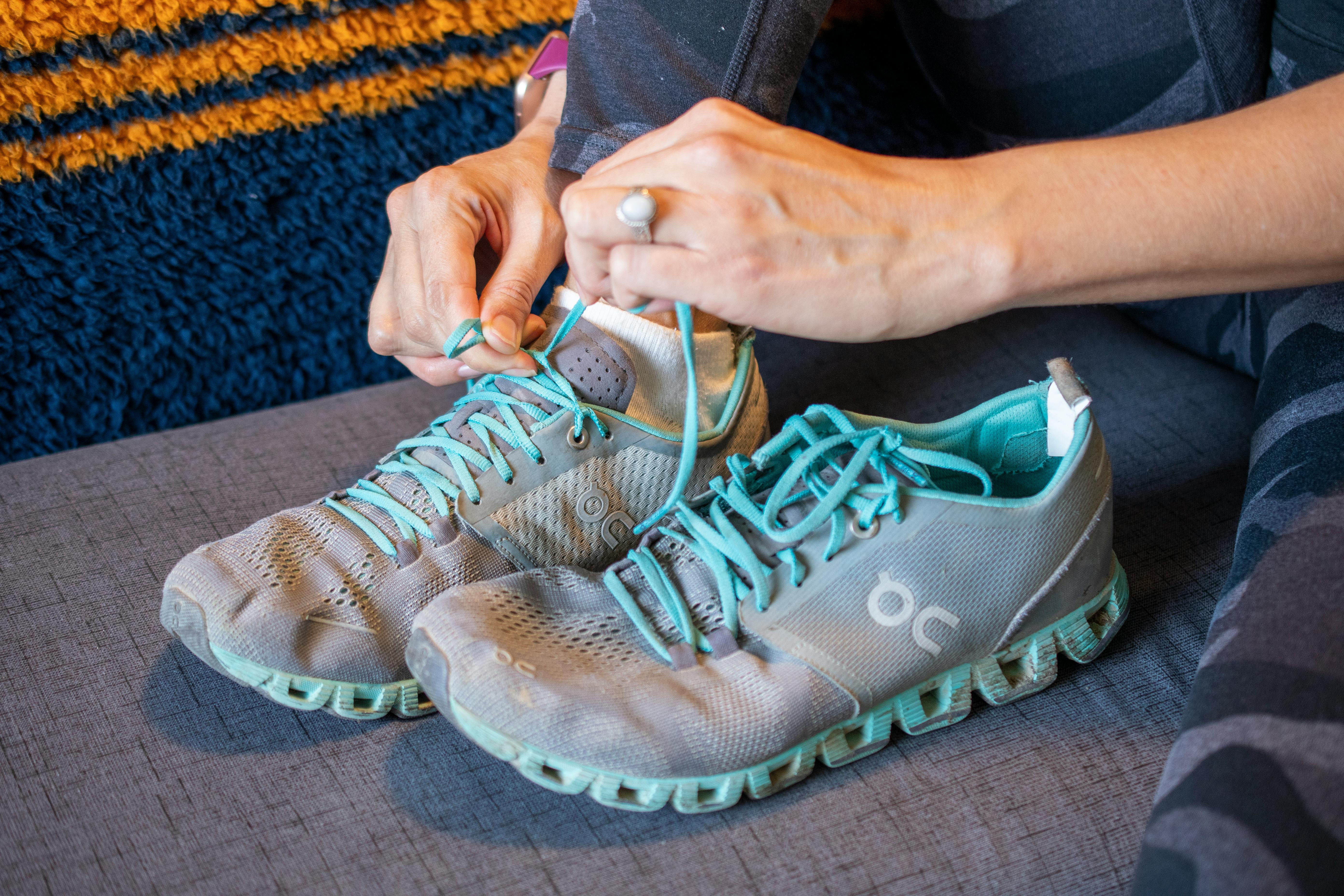 A woman tying the laces on a running shoe