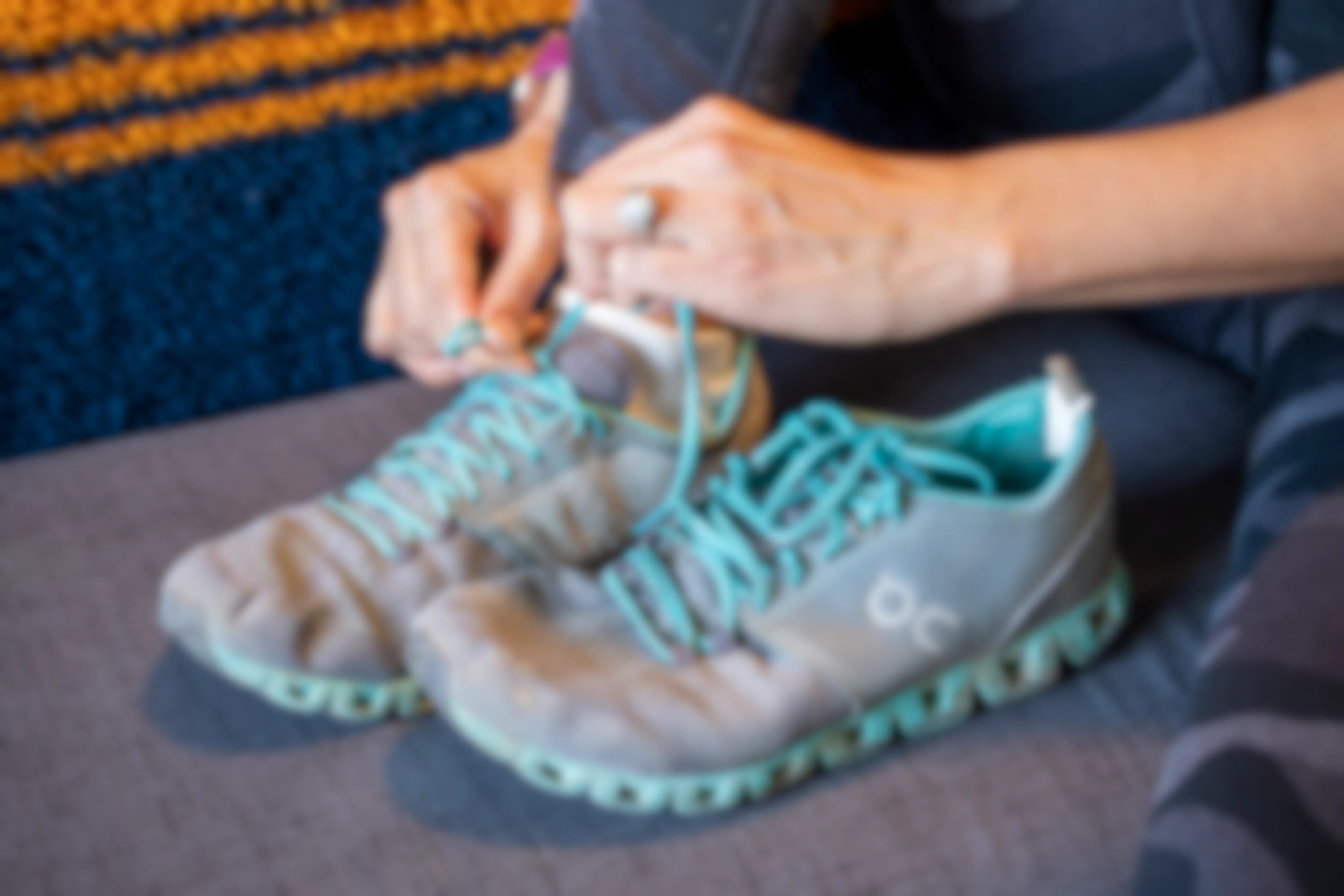 A woman tying the laces on a running shoe