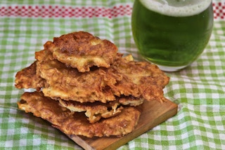 A stack of potato pancakes on a green tablecloth