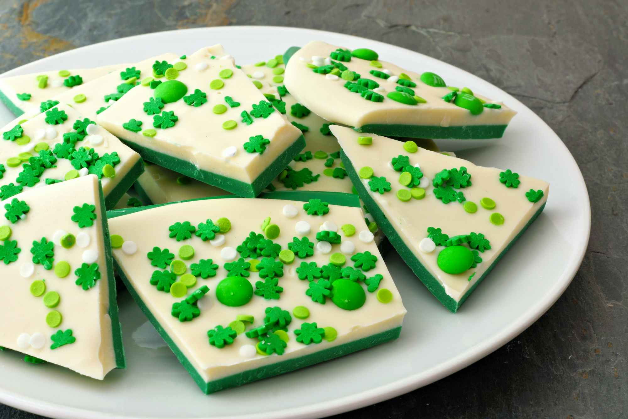 Chocolate bark decorated with green and shamrock candies