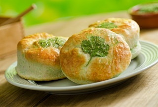 A plate of biscuits with an herb shaped like a clover baked into each one