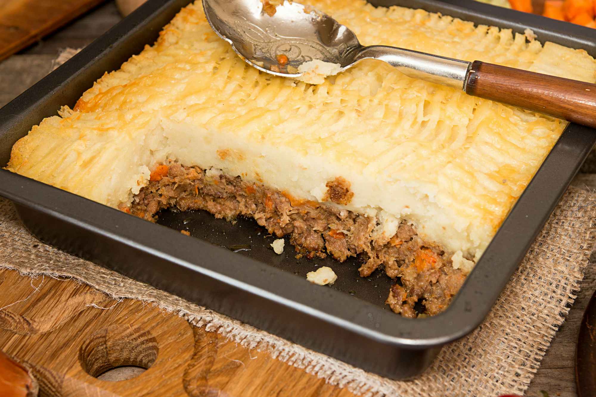 A pan of shepherd's pie with some taken out