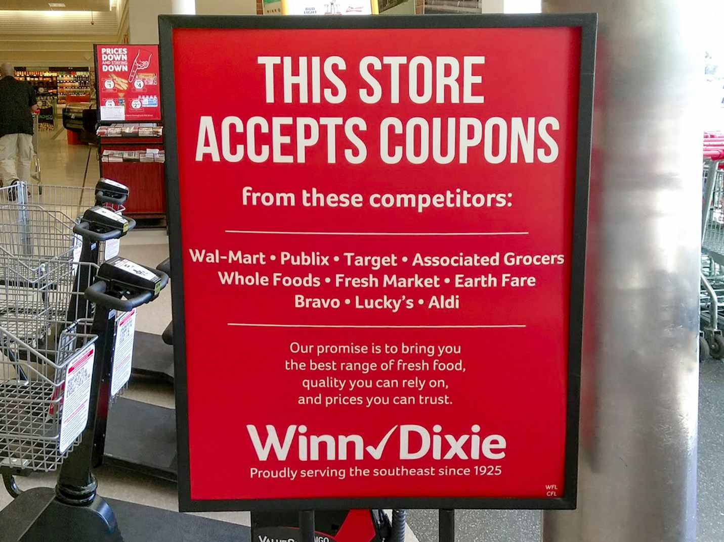 A sign inside Winn-Dixie listing the stores from which Winn-Dixie will accept competitor coupons.