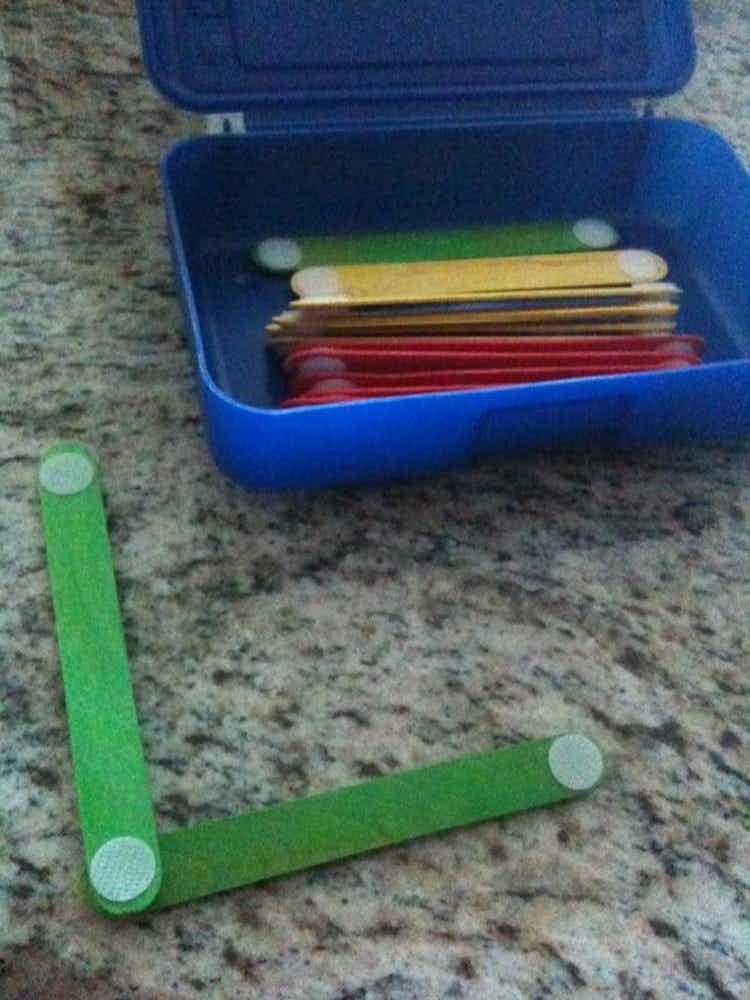 Attach velcro stickers to the ends of craft sticks.