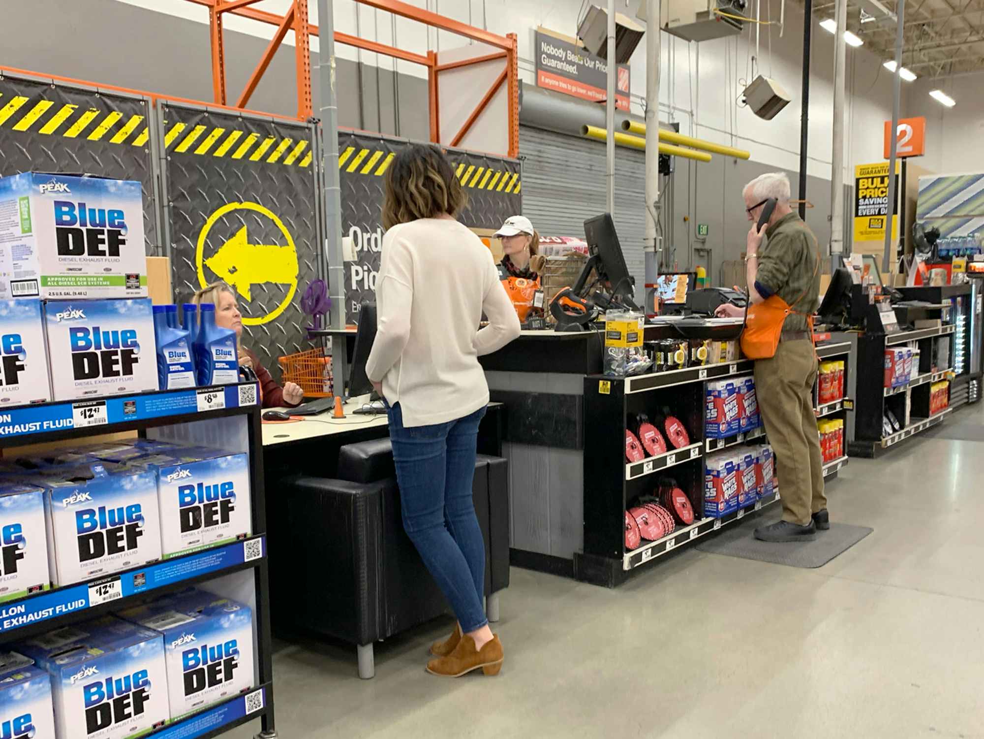 a person talking to an employee at the Pro Service desk in the home depot