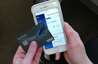 someone holding southwest credit card next to phone