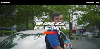 A person standing infront of a care on the Carvertise website.