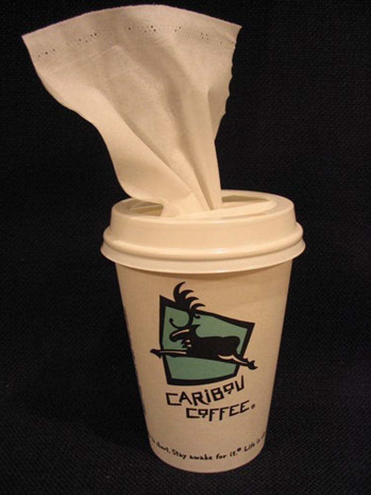 Make tissues easily accessible on the road with a disposable coffee cup.