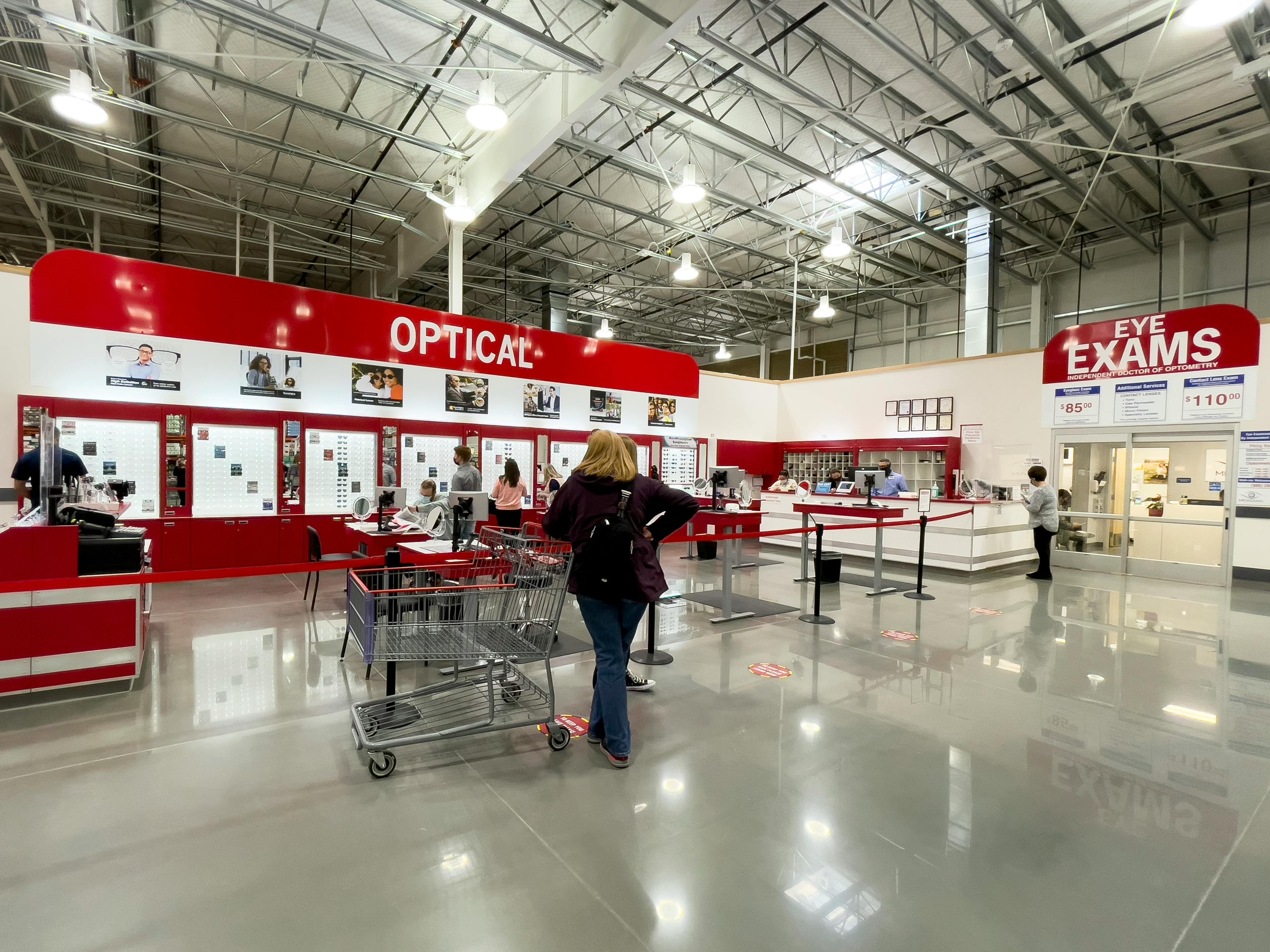 The Costco Optical and eye exams center with customers shopping and waiting in line.