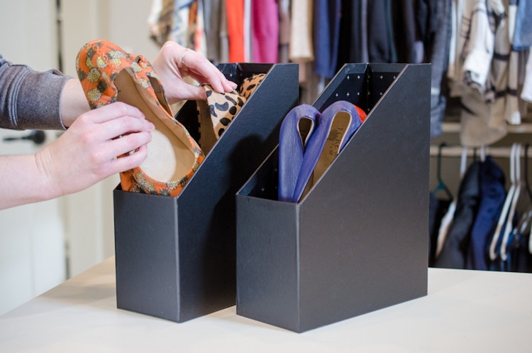 Someone organizing flats and flip-flops in magazine holders