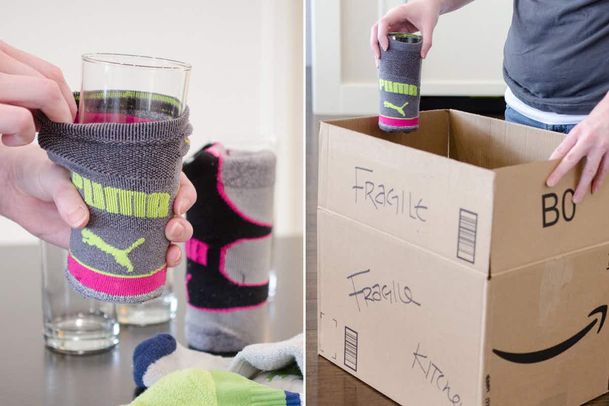 A person putting a glass into a sock to protect in a moving box.