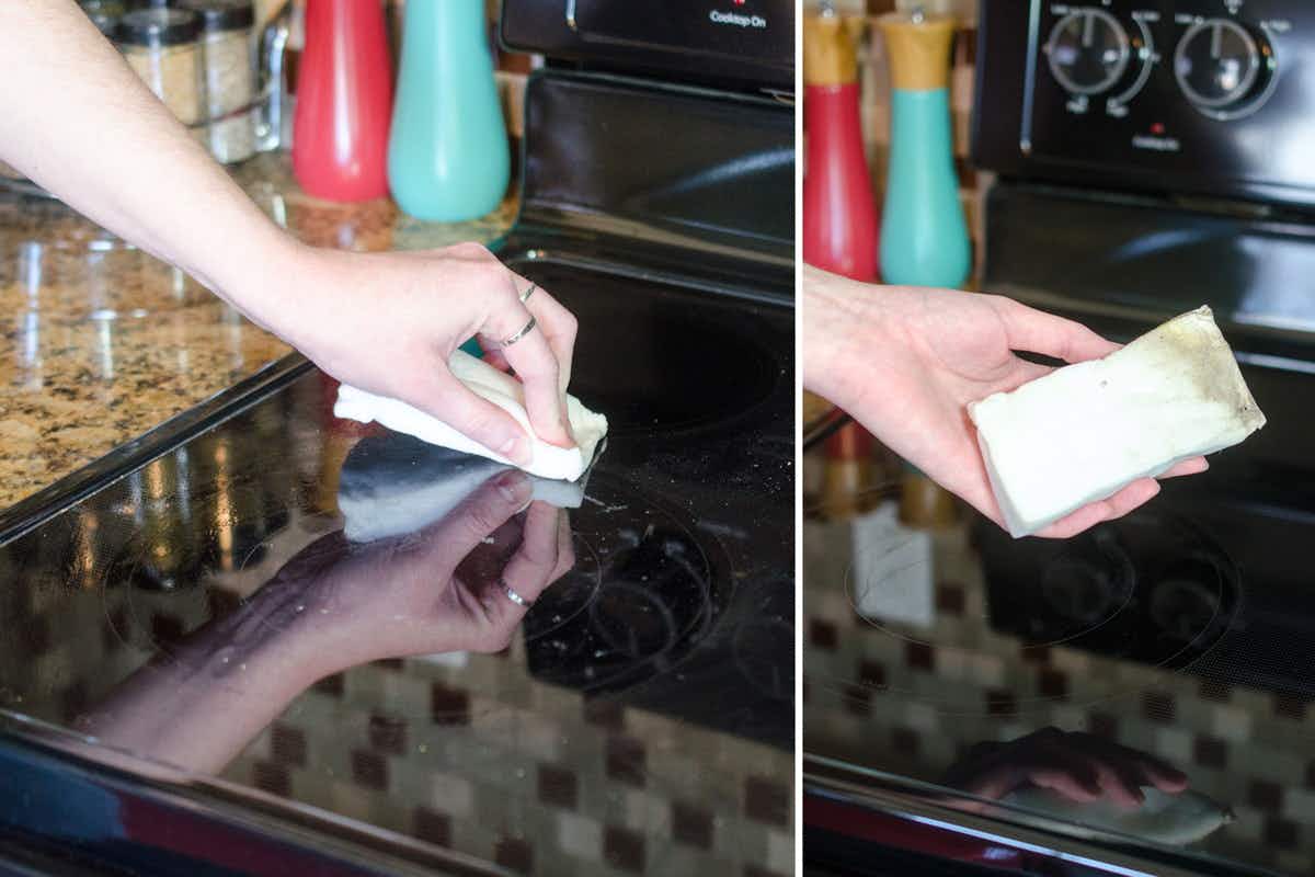 Someone cleaning a glass stovetop with a Magic Eraser.